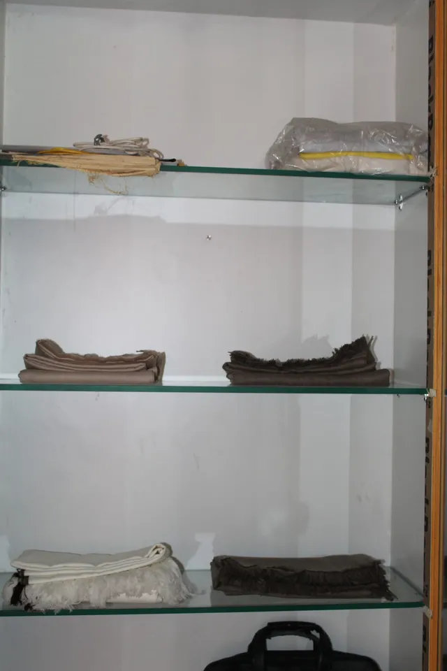 Photograph 4 of 28 from Thakur Ramsingh Ji's personal archive: his belongings and memorabilia on display shelves.