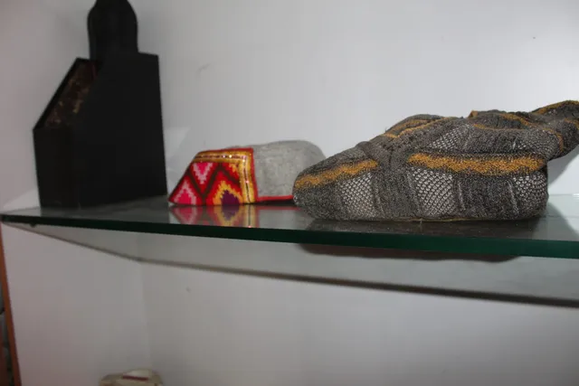 Photograph 6 of 28 from Thakur Ramsingh Ji's personal archive: his belongings and memorabilia on display shelves.