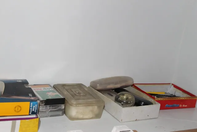 Photograph 9 of 28 from Thakur Ramsingh Ji's personal archive: his belongings and memorabilia on display shelves.