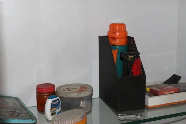 Photograph 10 of 28 from Thakur Ramsingh Ji's personal archive: his belongings and memorabilia on display shelves.