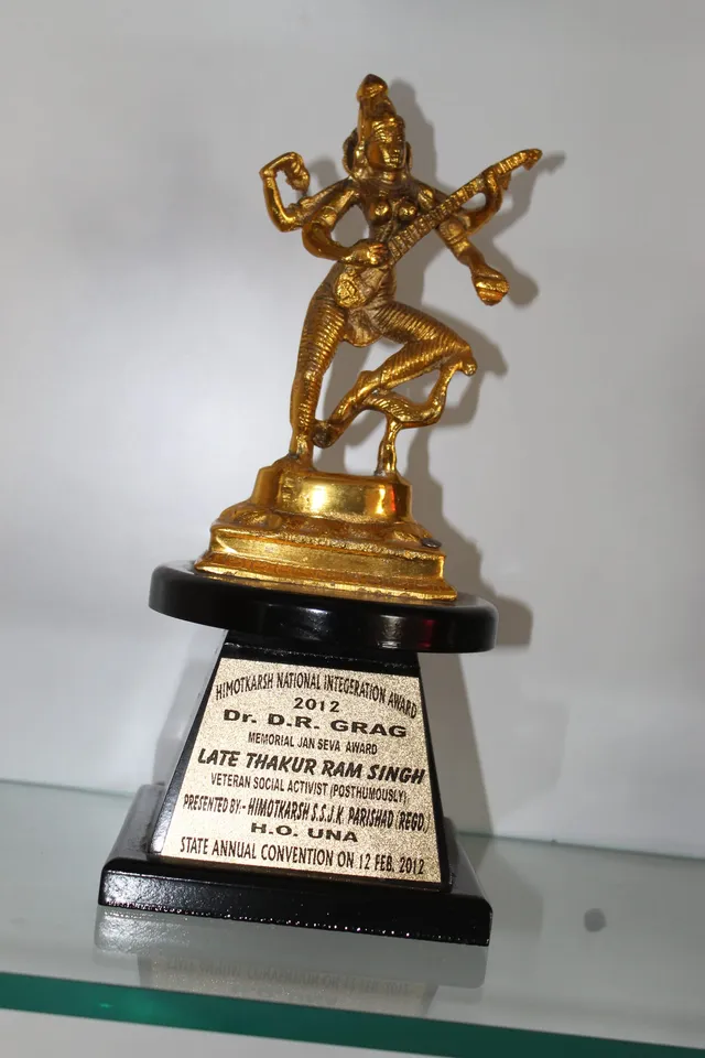 Photograph 19 of 28 from Thakur Ramsingh Ji's personal archive: his belongings and memorabilia on display shelves.