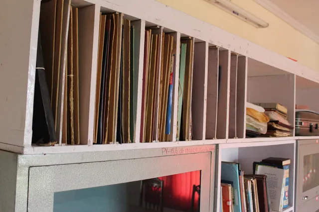 Photograph 24 of 28 from Thakur Ramsingh Ji's personal archive: his belongings and memorabilia on display shelves.