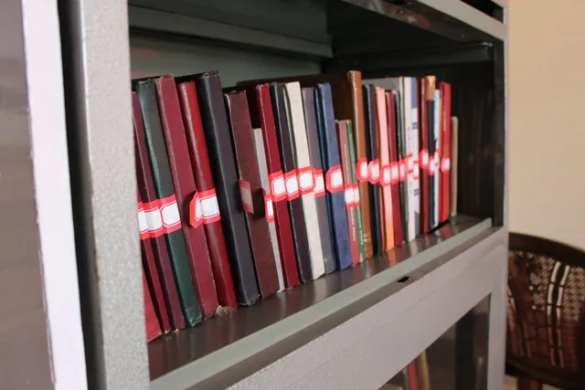 Photograph 25 of 28 from Thakur Ramsingh Ji's personal archive: his belongings and memorabilia on display shelves.