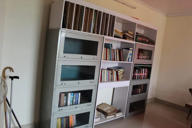 Photograph 27 of 28 from Thakur Ramsingh Ji's personal archive: his belongings and memorabilia on display shelves.